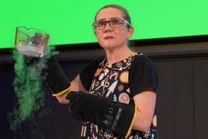 presenter holding a glass jug of liquid nitrogen